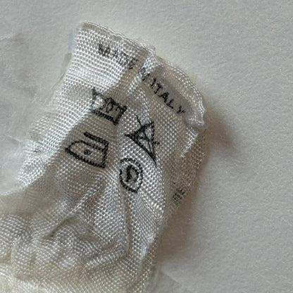 Textile label with 'Made in Italy' on a white fabric background