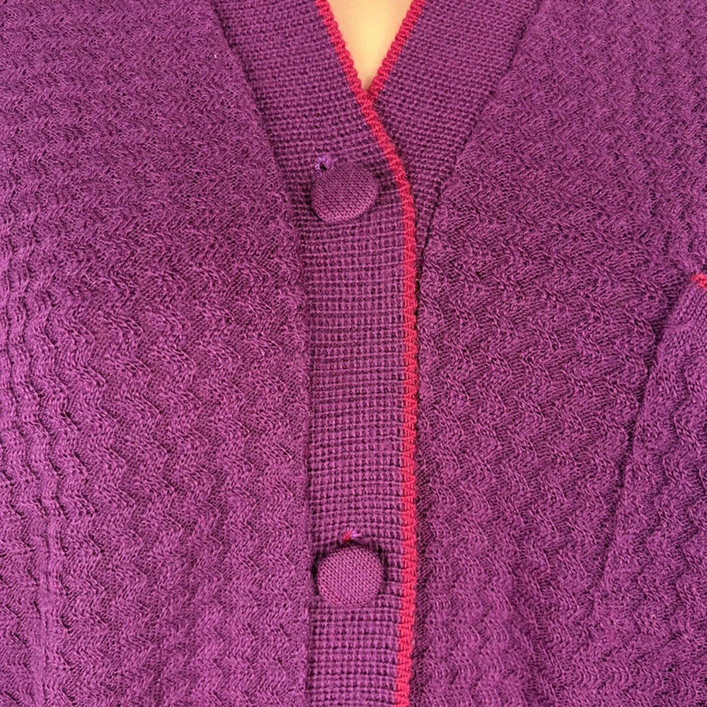 Close-up of a purple textured cardigan with buttons