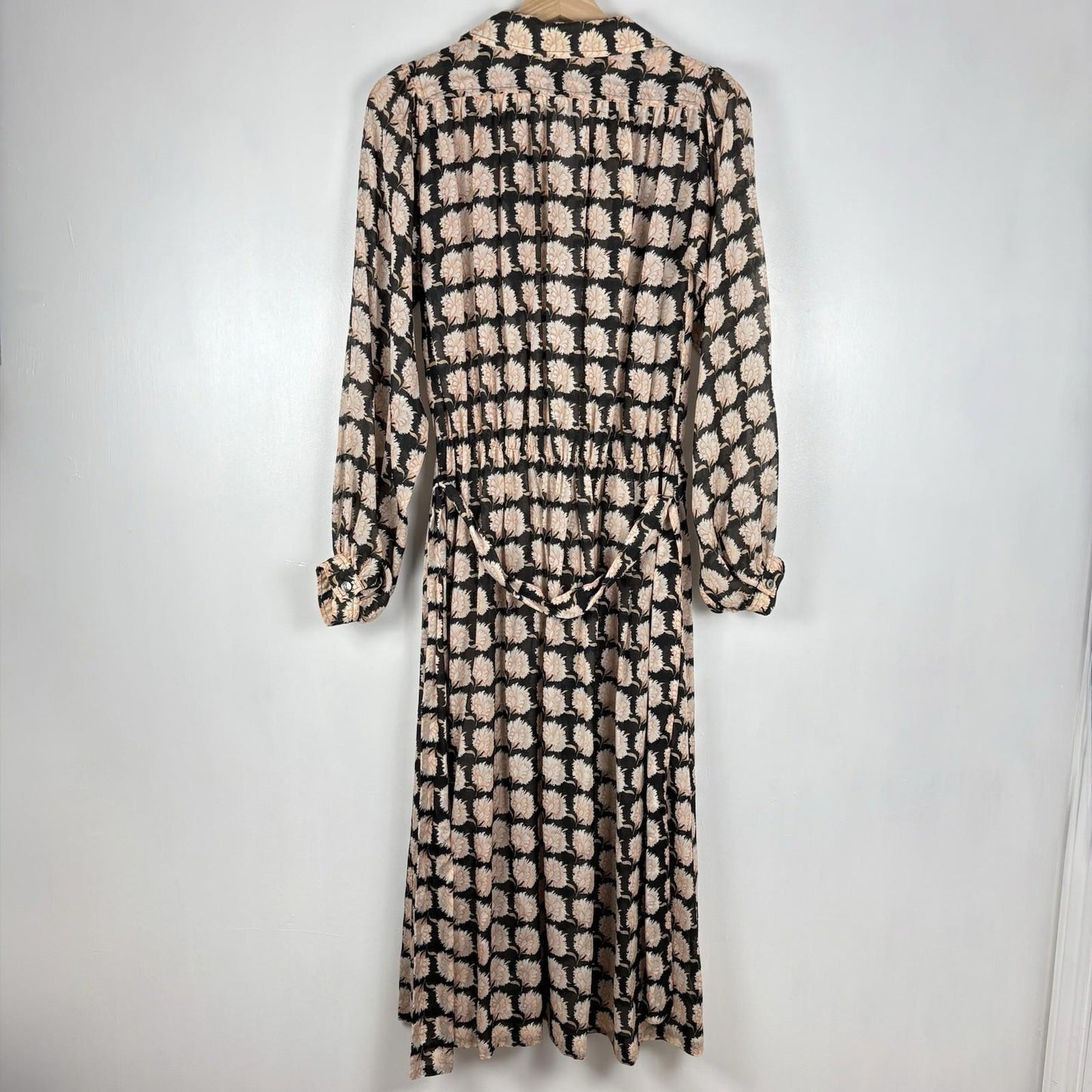 Long-sleeve dress with a black and beige pattern on a white background