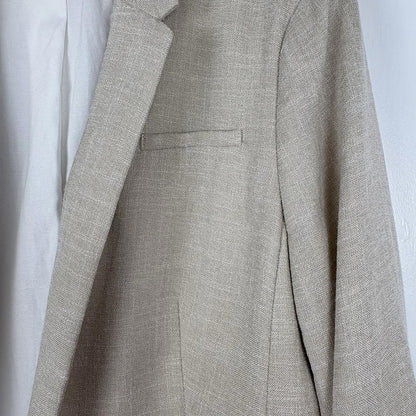 Close-up of a gray suit jacket on a white background