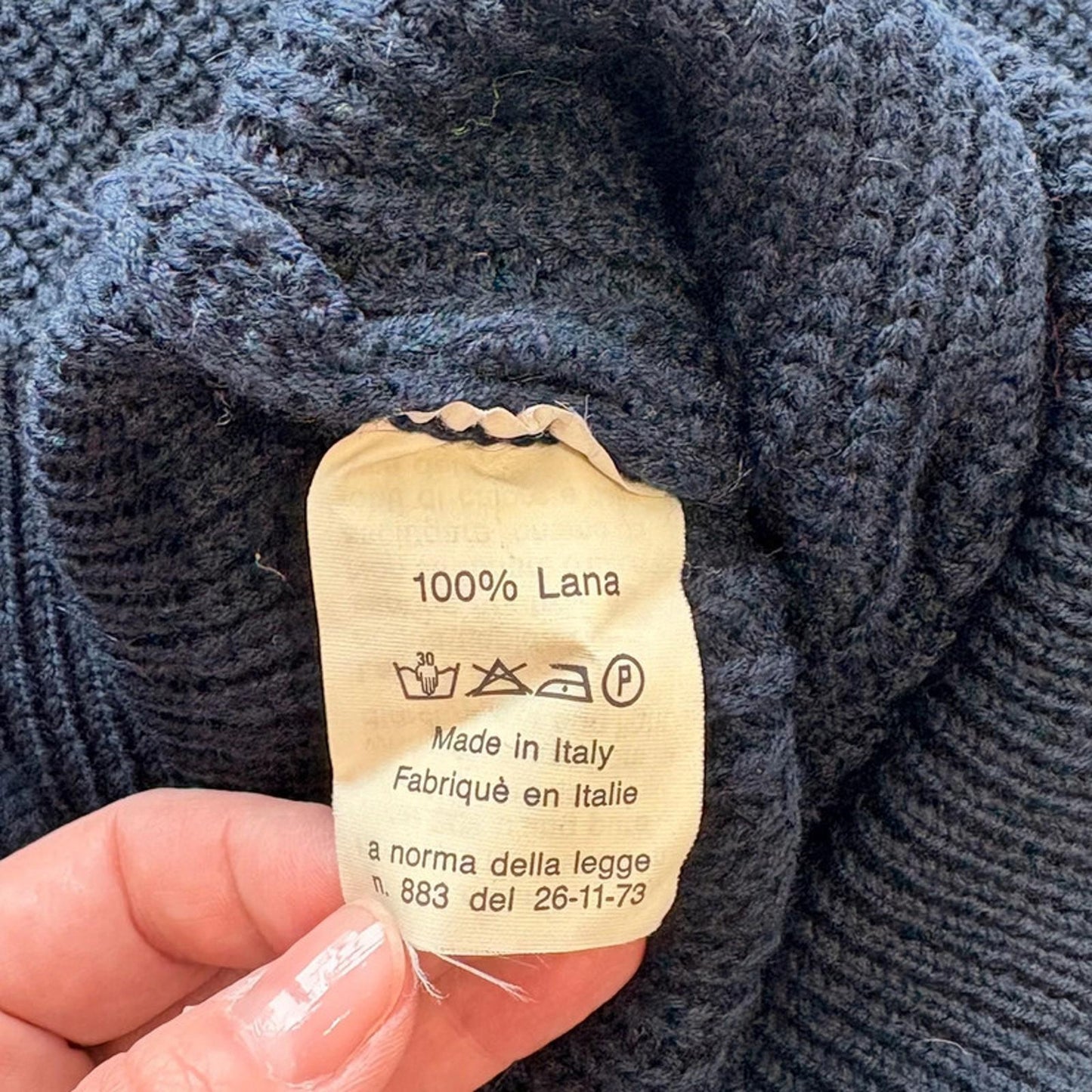 Textile label on a knitted fabric with 'Made in Italy' information