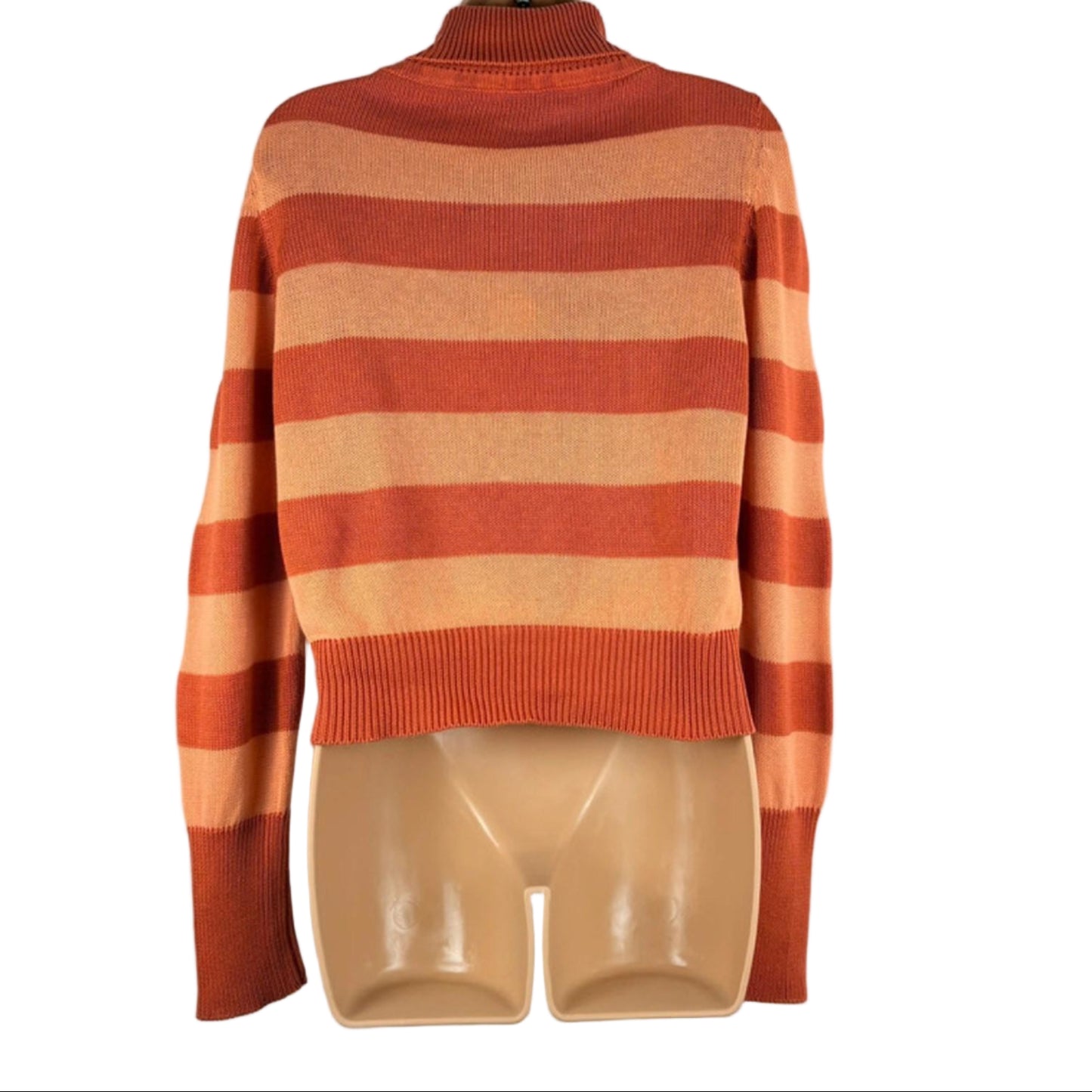 Orange and beige striped sweater on a hanger against a white background