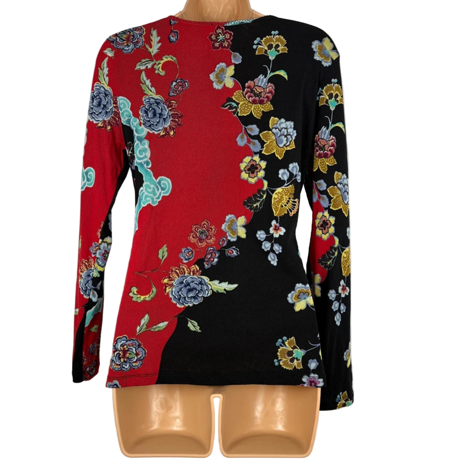 Colorful floral-patterned blouse on a mannequin against a white background