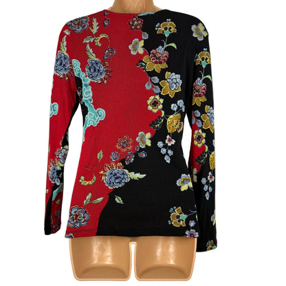 Colorful floral-patterned blouse on a mannequin against a white background
