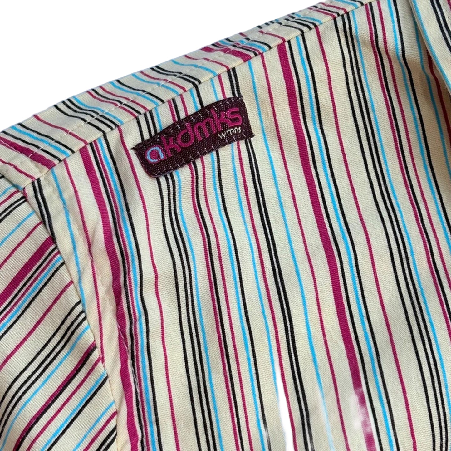 Striped fabric with a visible brand label on a light blue background