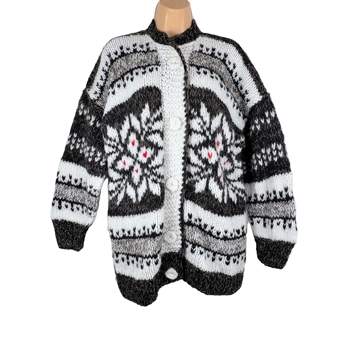 Knitted cardigan with a black and white pattern on a white background