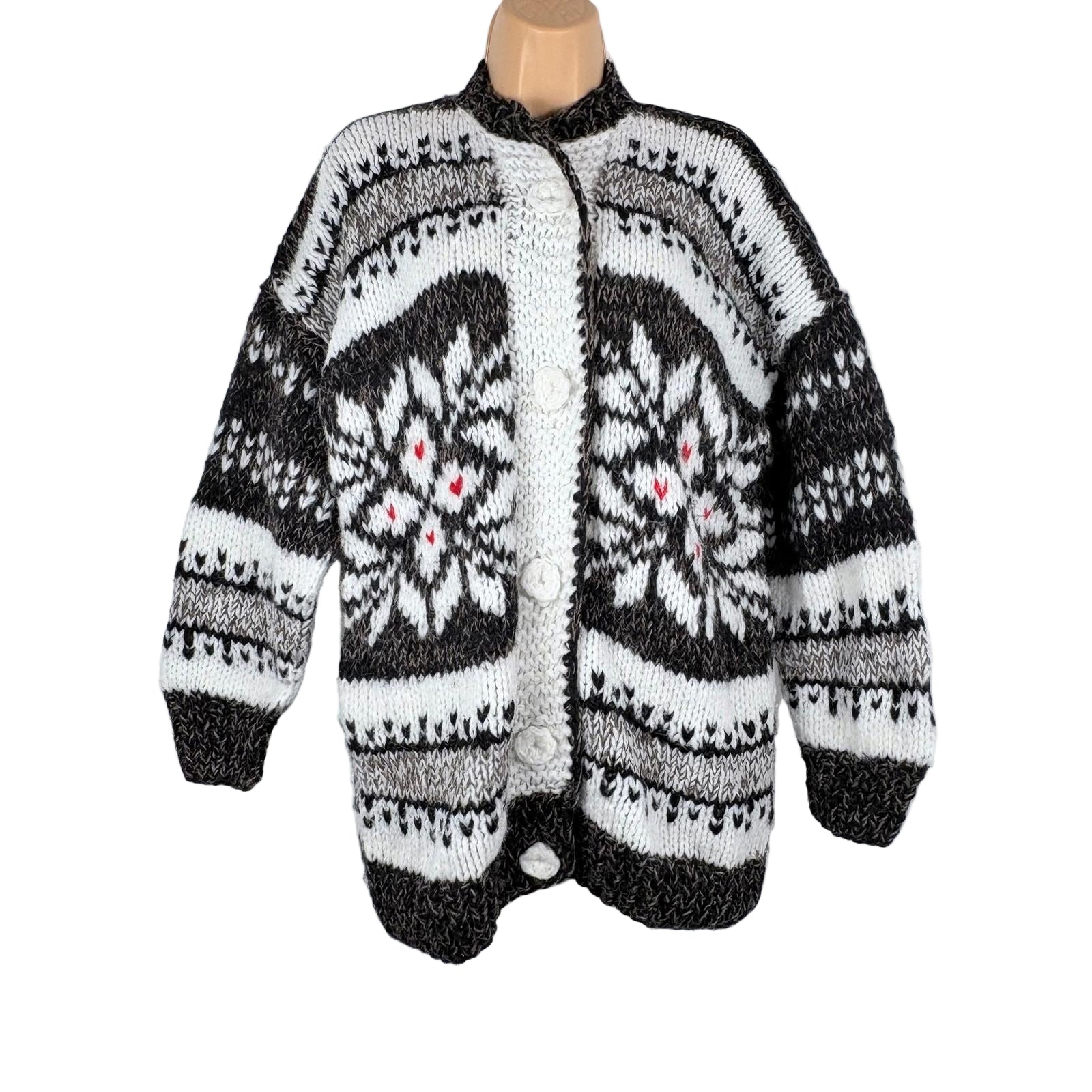 Knitted cardigan with a black and white pattern on a white background