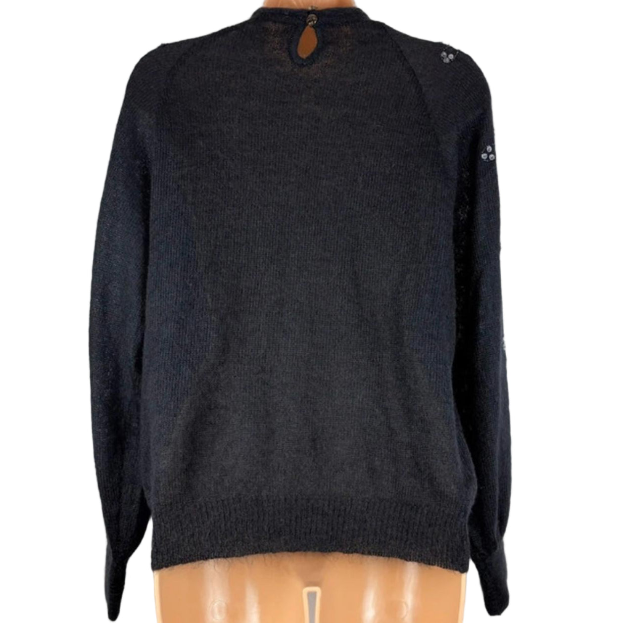 Black sweater on a mannequin against a white background