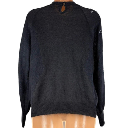 Black sweater on a mannequin against a white background