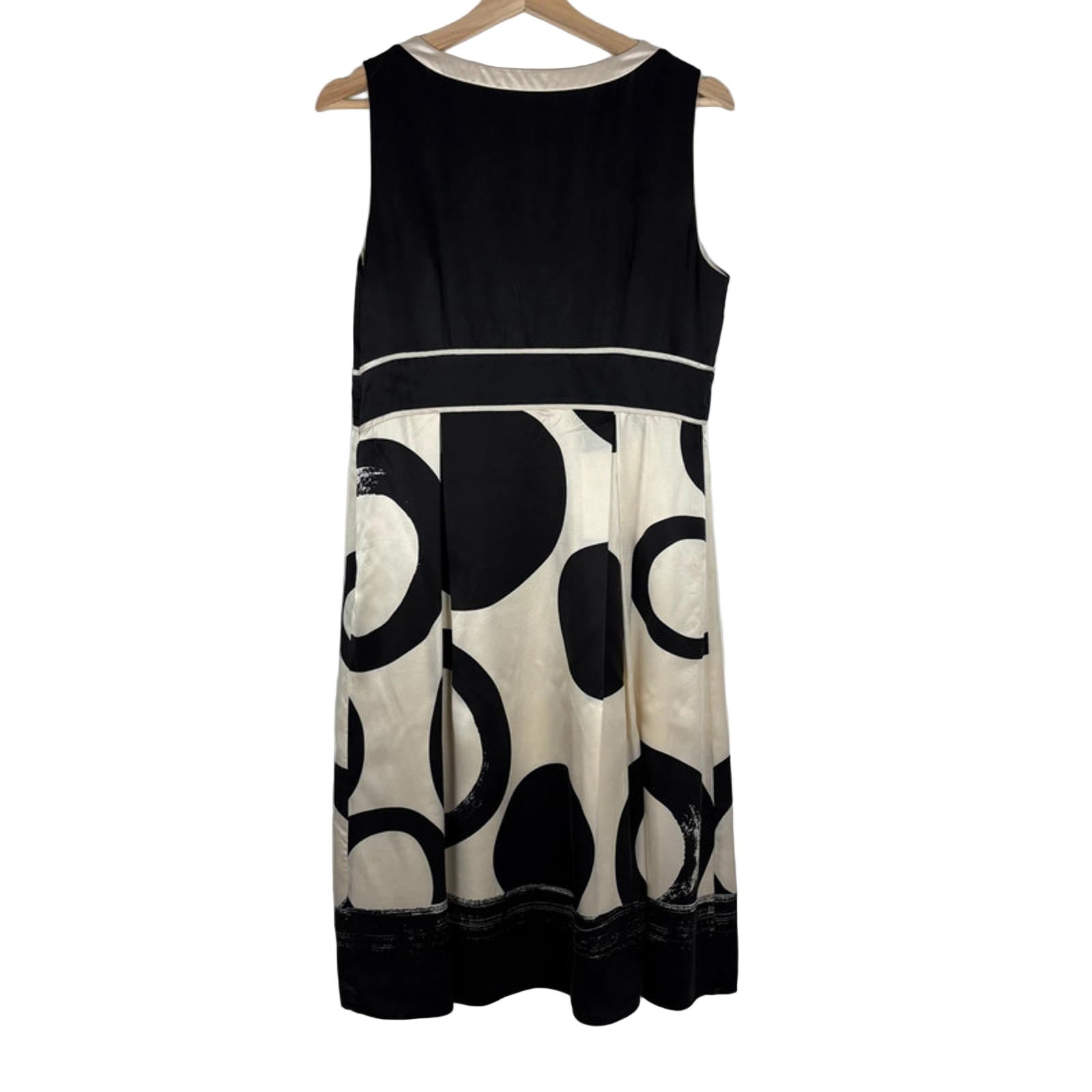 Black and white dress with abstract pattern on a hanger against a white background