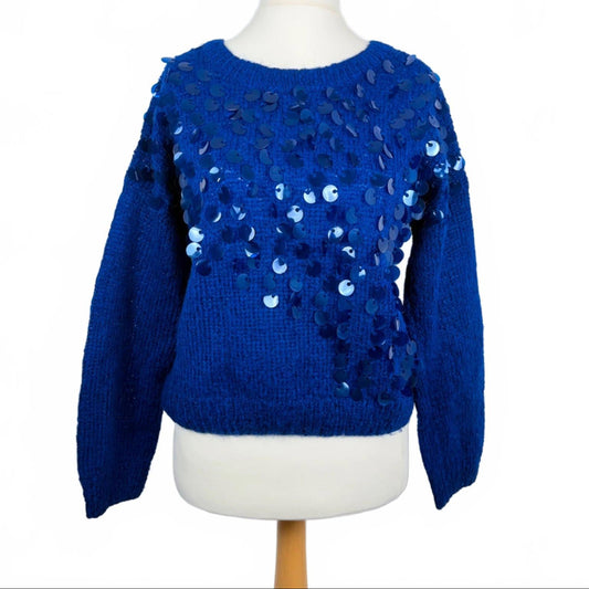 Blue sweater with sequin details on a mannequin against a white background
