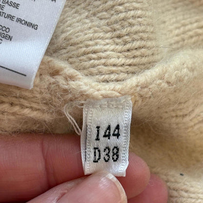 Close-up of a fabric tag with numbers on a textured beige background