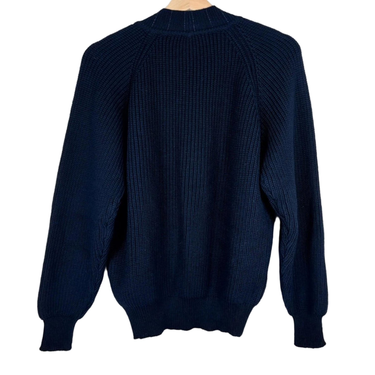Navy blue sweater on a wooden hanger against a white background
