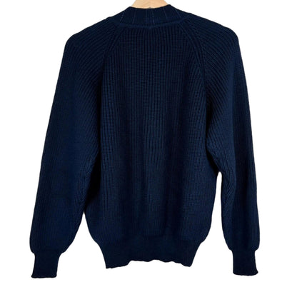 Navy blue sweater on a wooden hanger against a white background