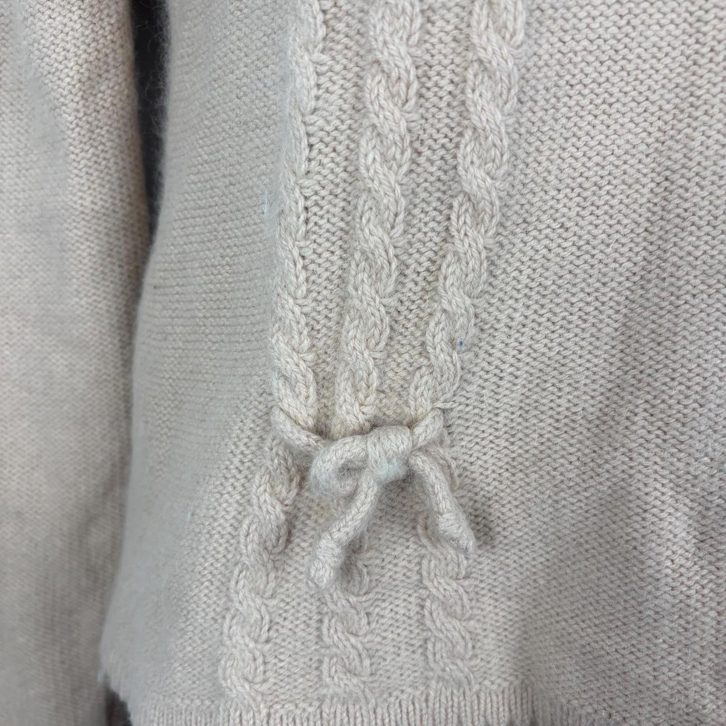 Close-up of a pink sweater cable pattern.