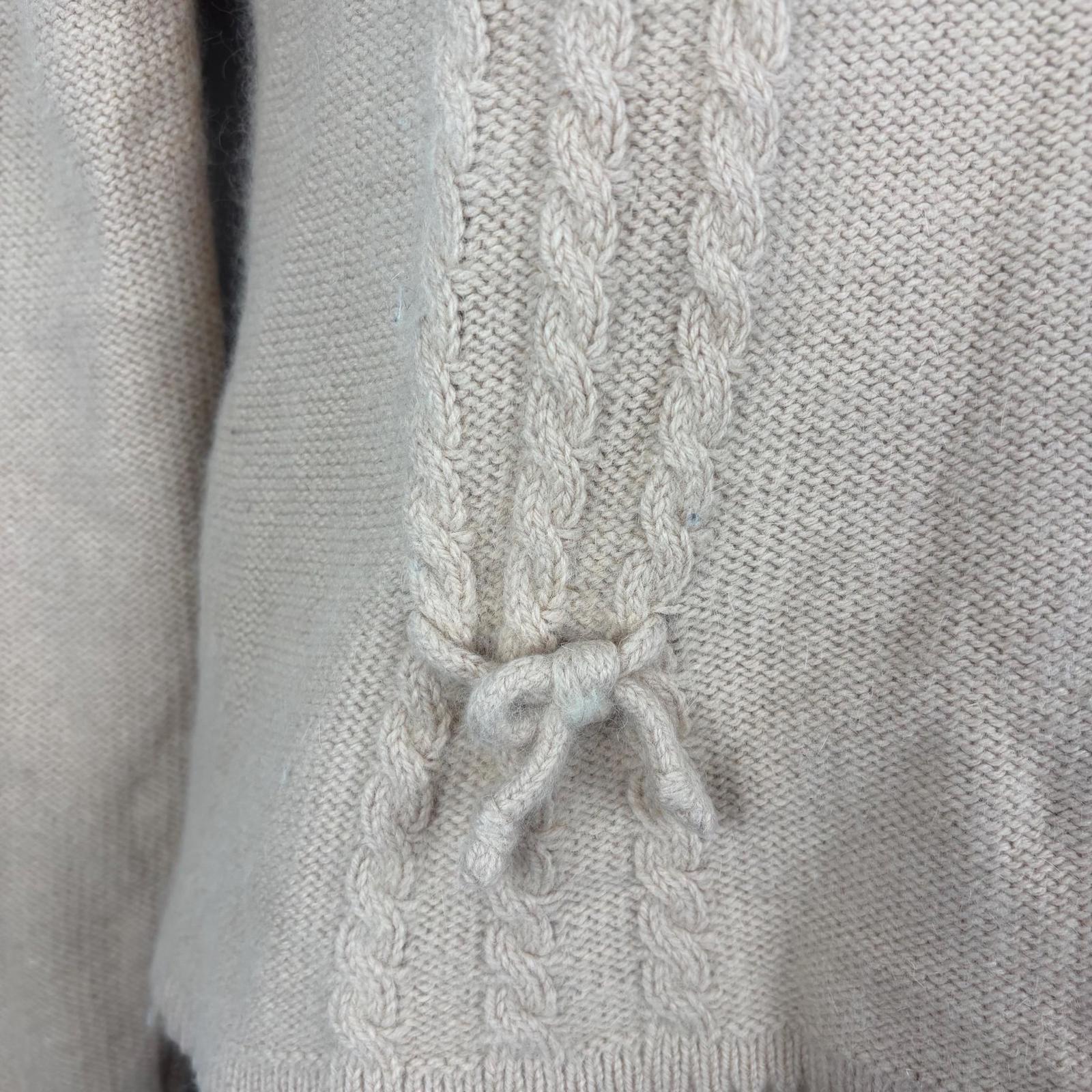 Close-up of a pink sweater cable pattern.