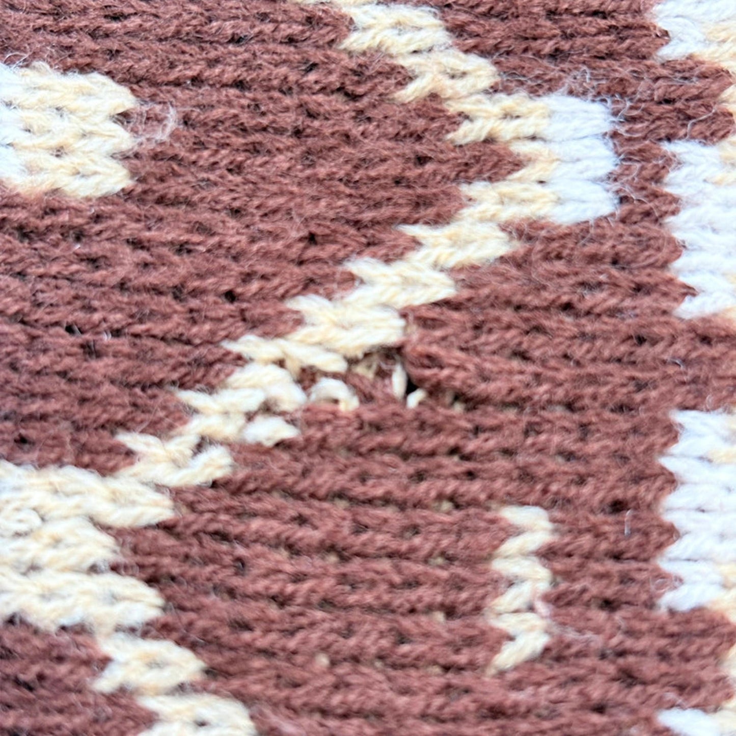 Close up showing small knit hole
