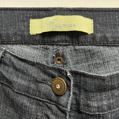 Close-up of a denim fabric with a brand label and button