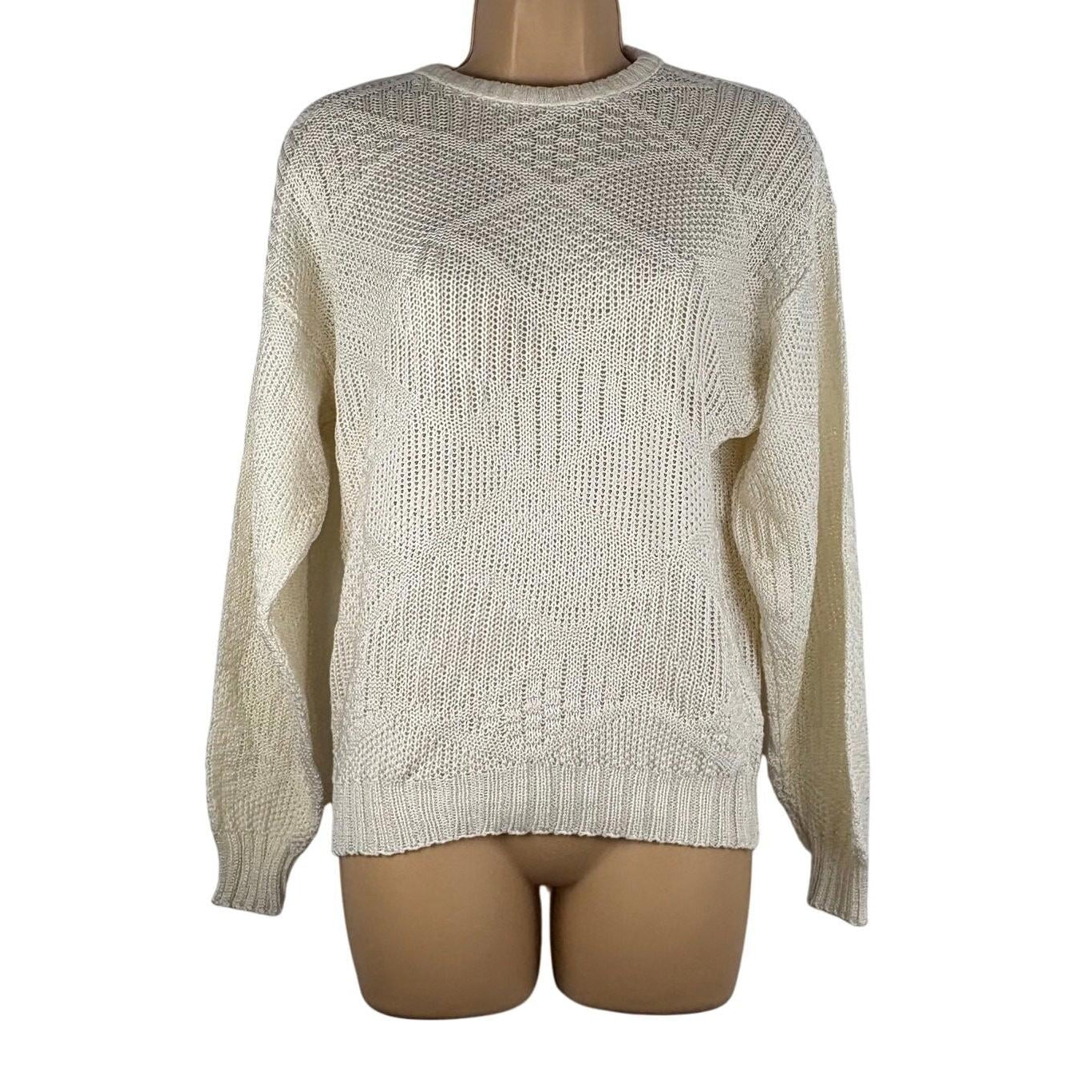 Beige knitted sweater on a mannequin against a white background