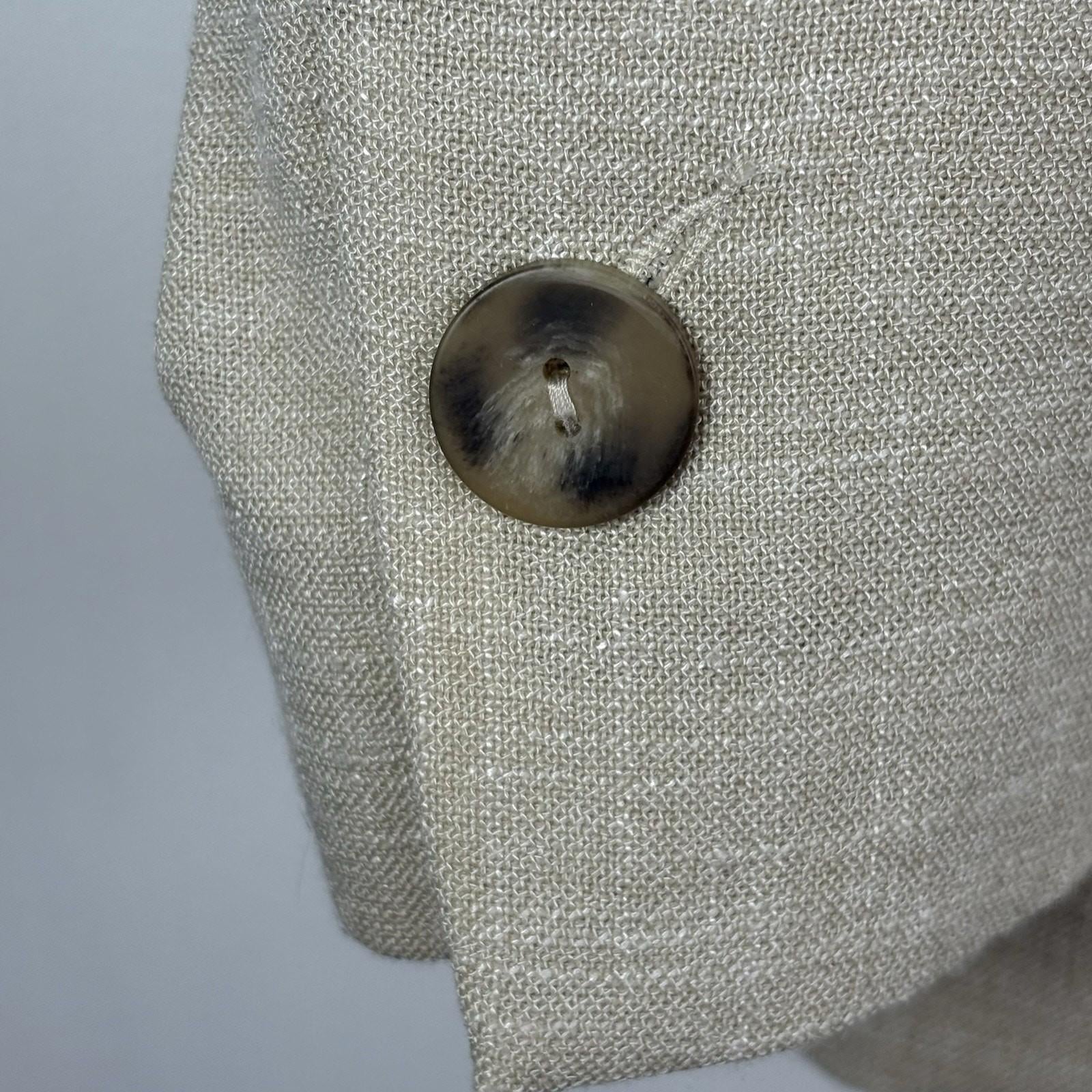 Close-up of a textured gray fabric surface with a button.