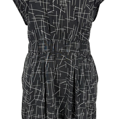 Black dress with white geometric pattern on a white background