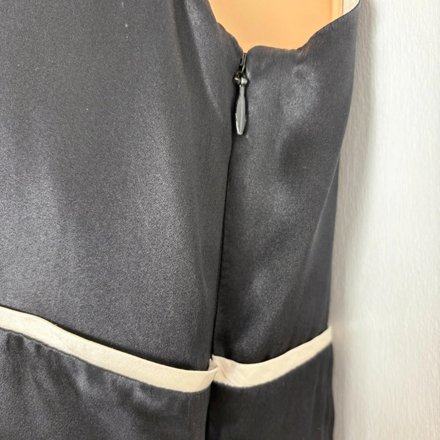 Close-up of a dress garment with a zipper on a white background