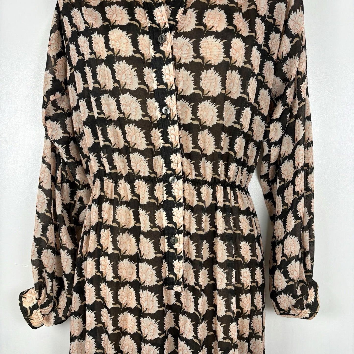 Long-sleeve dress with a black and beige pattern on a white background