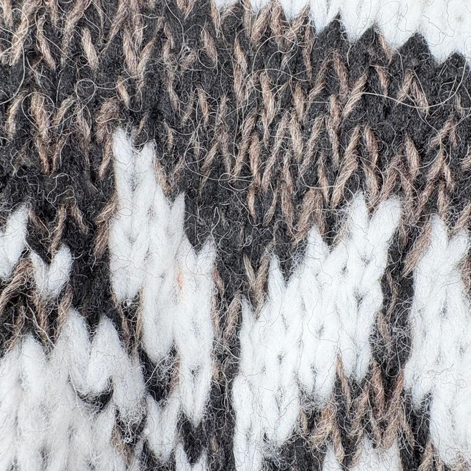 Close-up of a textured fabric with brown, white, and black pattern