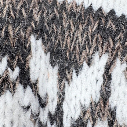 Close-up of a textured fabric with brown, white, and black pattern