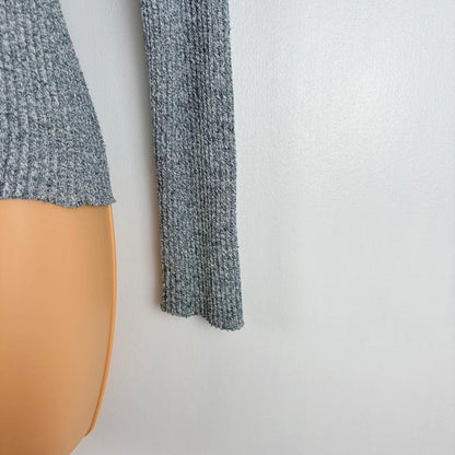 Gray knitted sweater on a mannequin against a white background