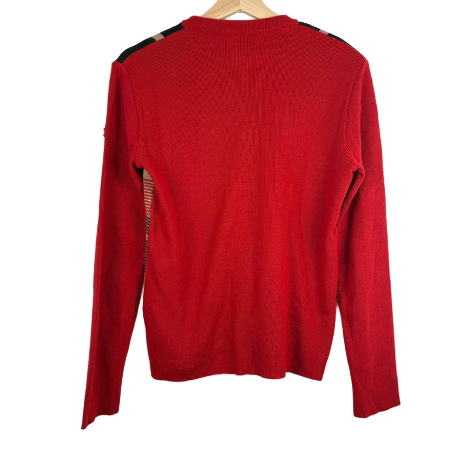 Red long-sleeve sweater on a hanger against a white background