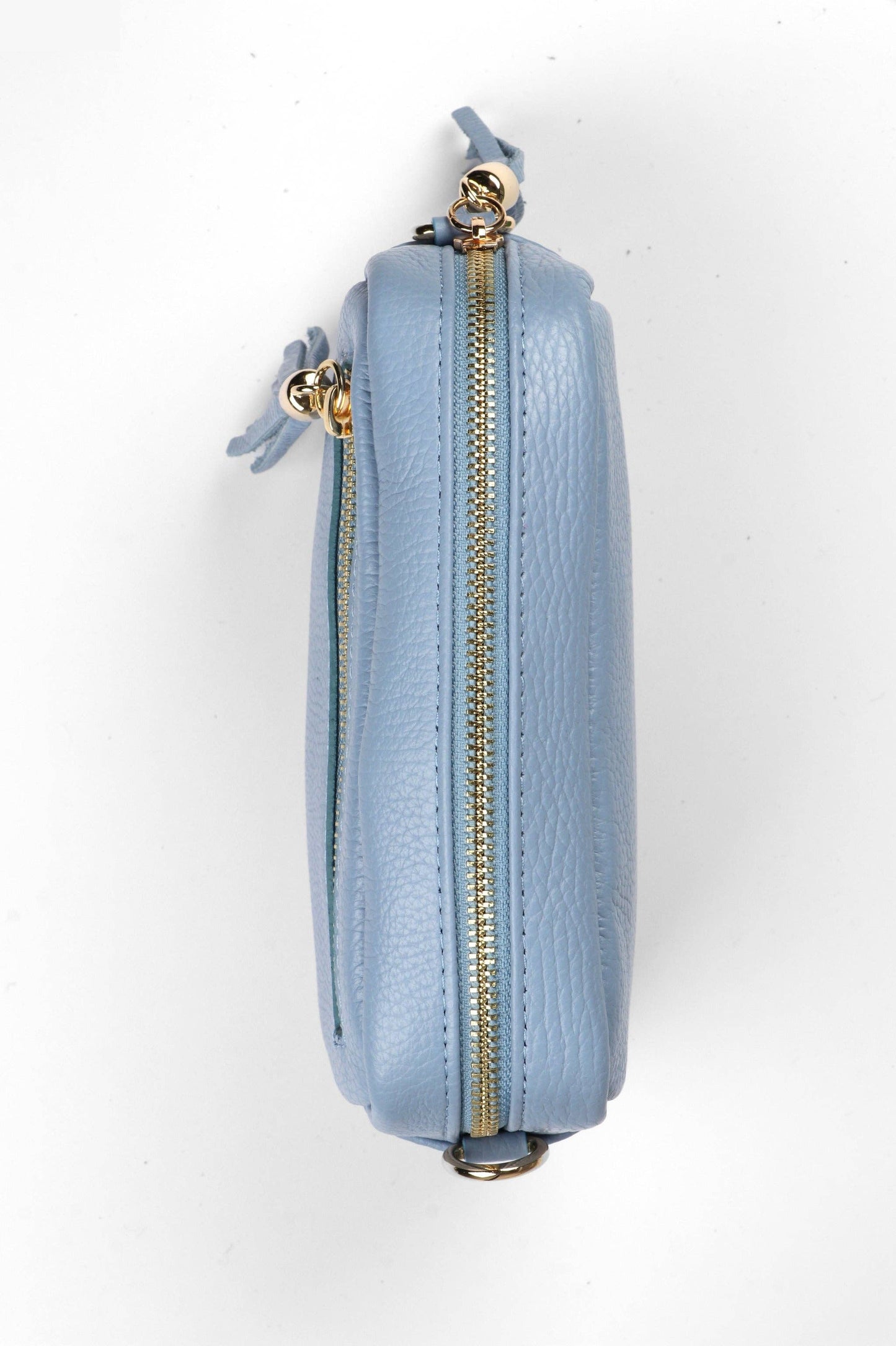 Light blue purse with gold zipper on a white background