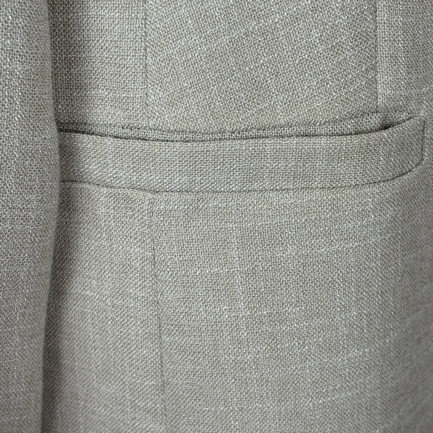 Close-up of a textured gray fabric with a pocket detail
