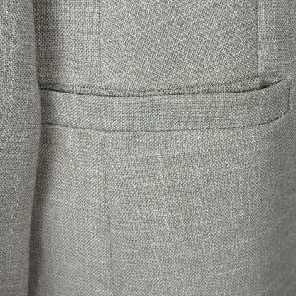 Close-up of a textured gray fabric with a pocket detail