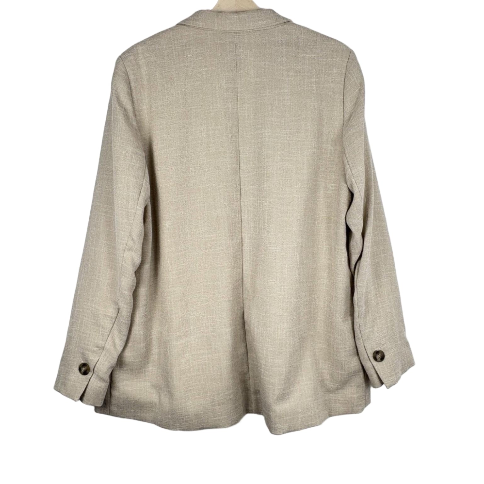 Beige blazer on a hanger against a white background