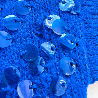 Close up of sequins on a blue jumper