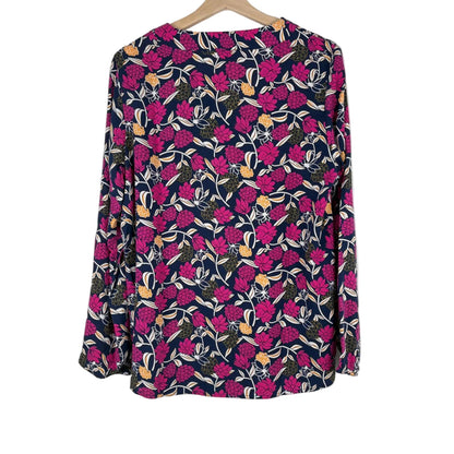 Floral patterned shirt on a hanger against a white background