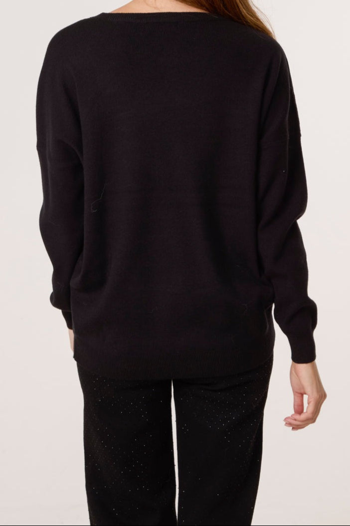Person wearing a black sweater and pants on a plain background