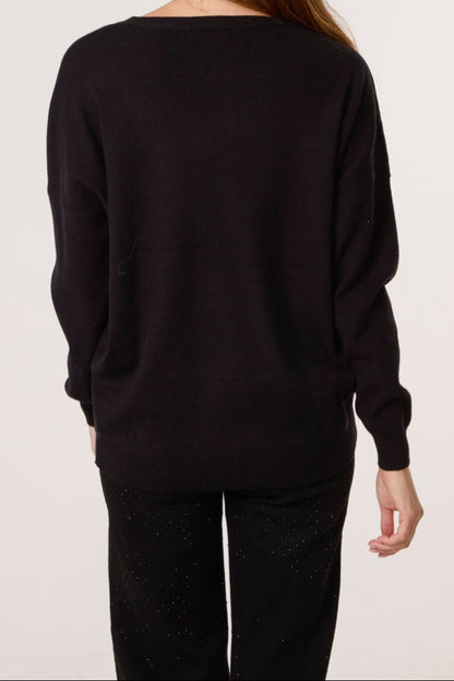 Person wearing a black sweater and pants on a plain background